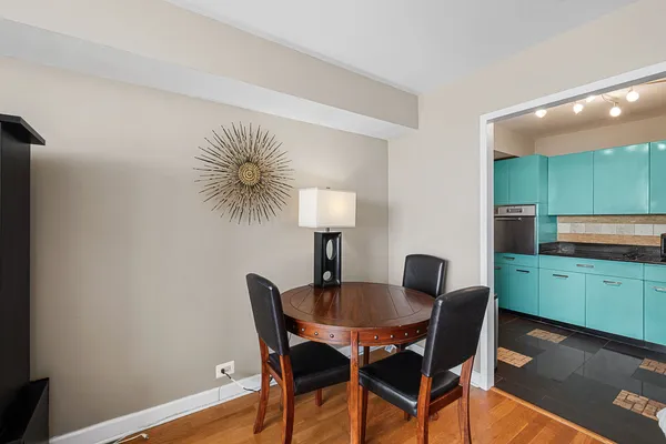 a dining room with furniture and wooden floor