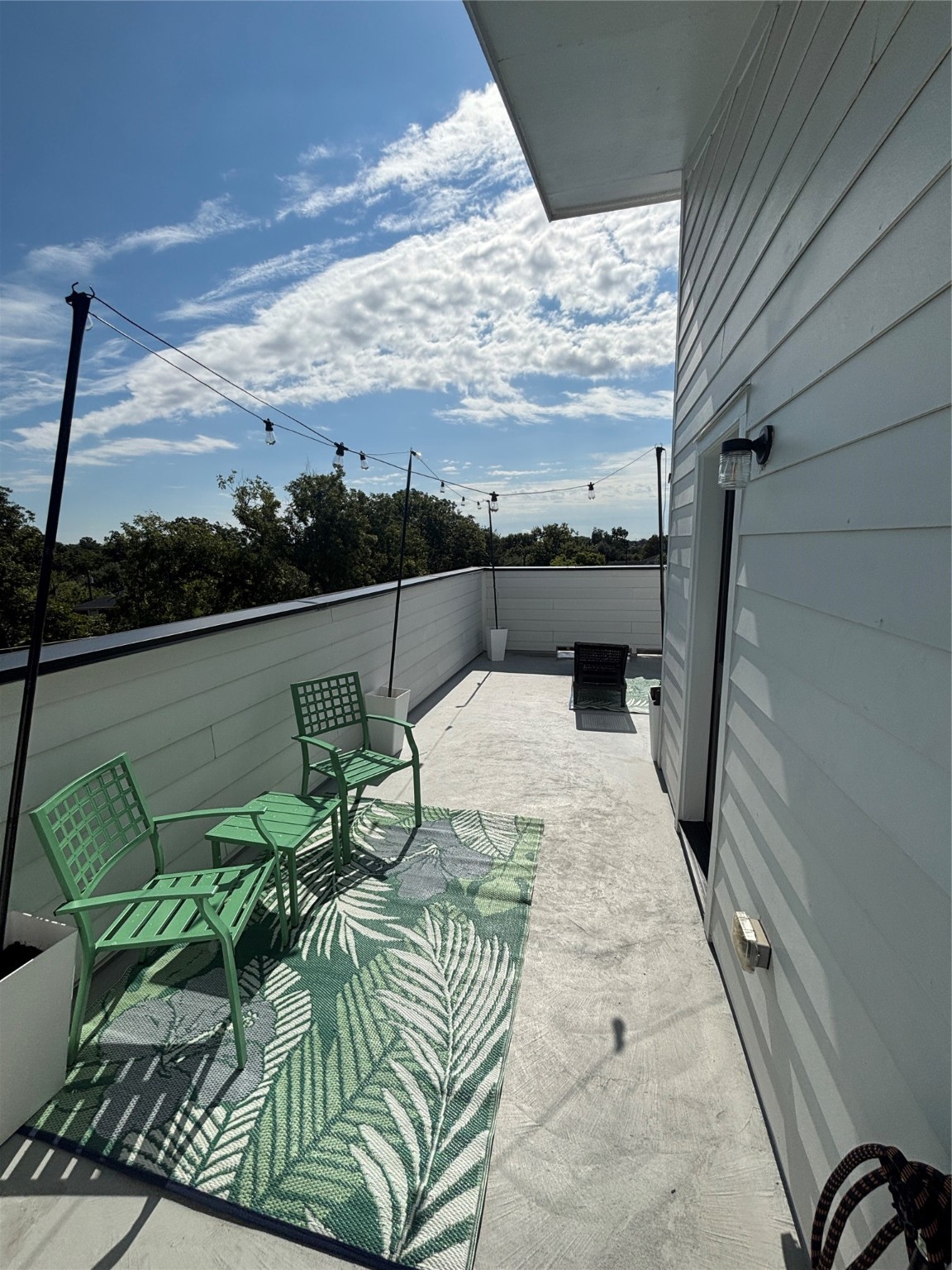 3824 Fulton Street, Unit 102 Houston, TX 77009 - Photo 14 of 16 a balcony with furniture and a floor to ceiling window