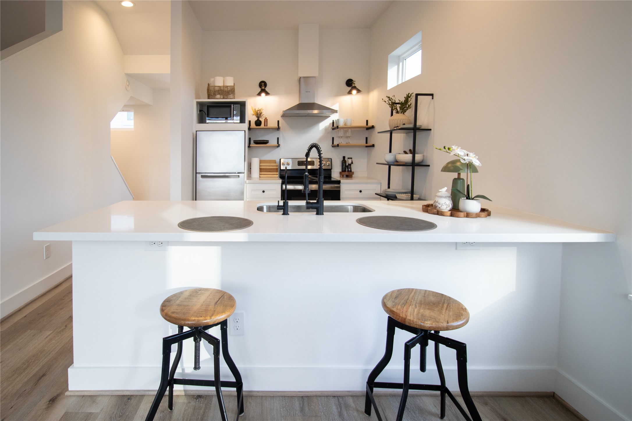 3824 Fulton Street, Unit 102 Houston, TX 77009 - Photo 6 of 16 a dining room table chairs and a chandelier