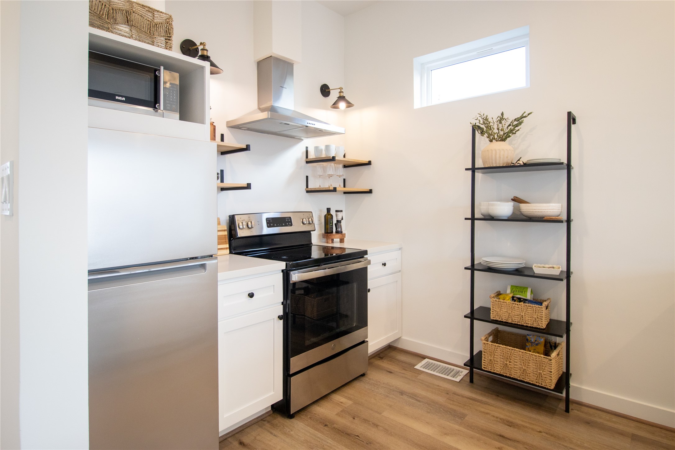 3824 Fulton Street, Unit 102 Houston, TX 77009 - Photo 7 of 16 a kitchen with stainless steel appliances a stove and a refrigerator