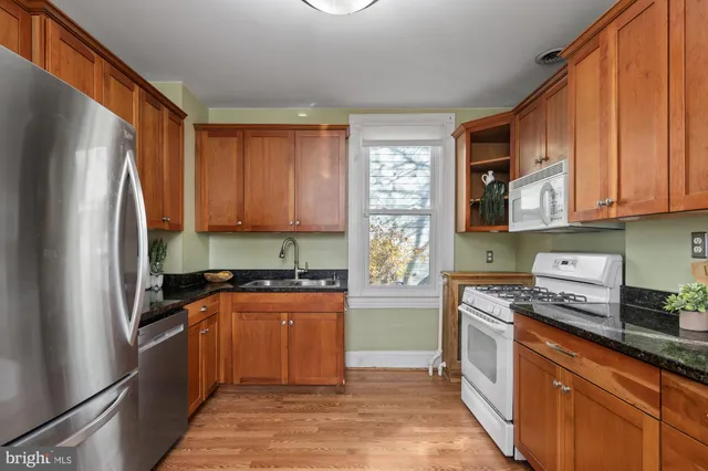 a kitchen with stainless steel appliances granite countertop a refrigerator sink and cabinets