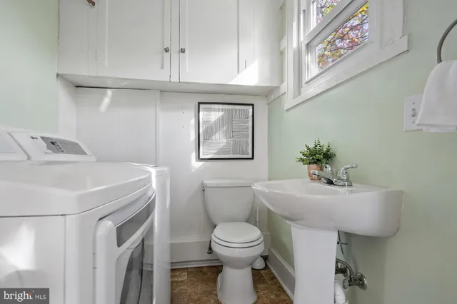 a bathroom with a sink a toilet and mirror