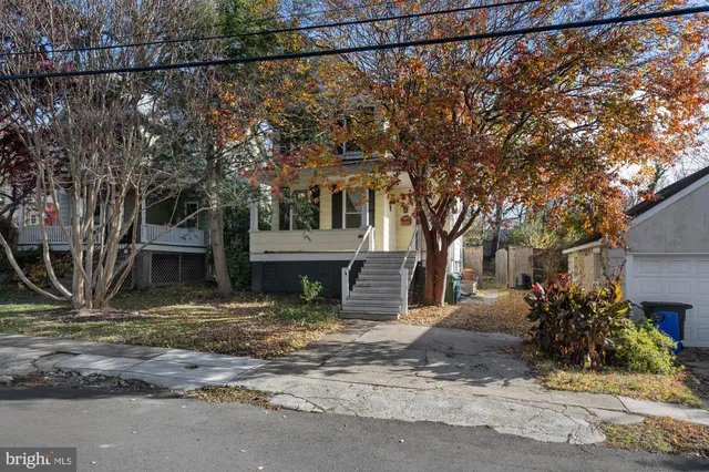 a view of a house with a tree in the background