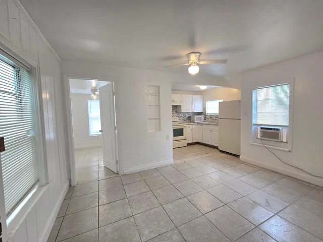 a view of a kitchen with a sink and dishwasher cabinets