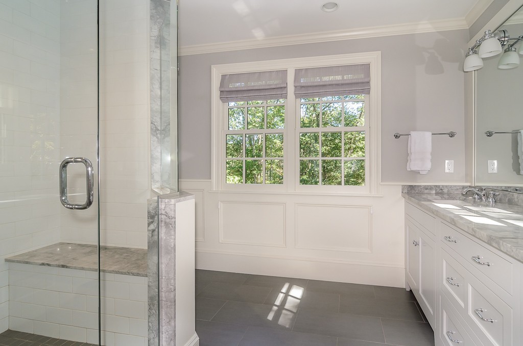 82 Whittier Road Wellesley, MA 02481 - Photo 13 of 28 a bathroom with a granite countertop sink a shower and a window
