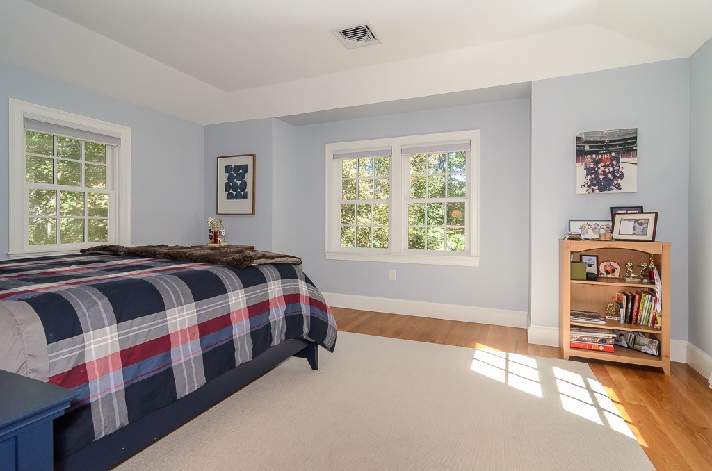 82 Whittier Road Wellesley, MA 02481 - Photo 17 of 28 a spacious bedroom with a bed and a window