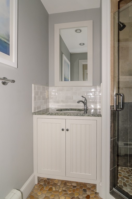 82 Whittier Road Wellesley, MA 02481 - Photo 21 of 28 a bathroom with a granite countertop sink and a mirror