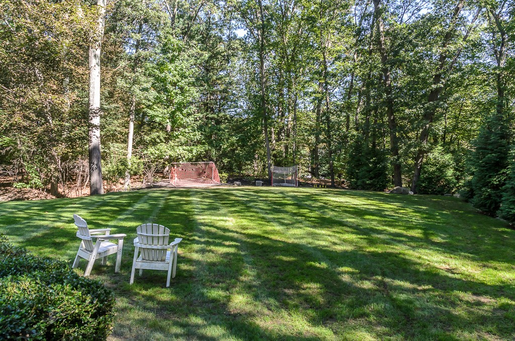 82 Whittier Road Wellesley, MA 02481 - Photo 28 of 28 a backyard of a house with table and chairs