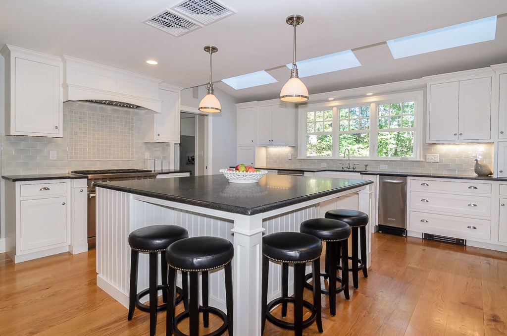 82 Whittier Road Wellesley, MA 02481 - Photo 5 of 28 a kitchen with a table chairs stove and cabinets