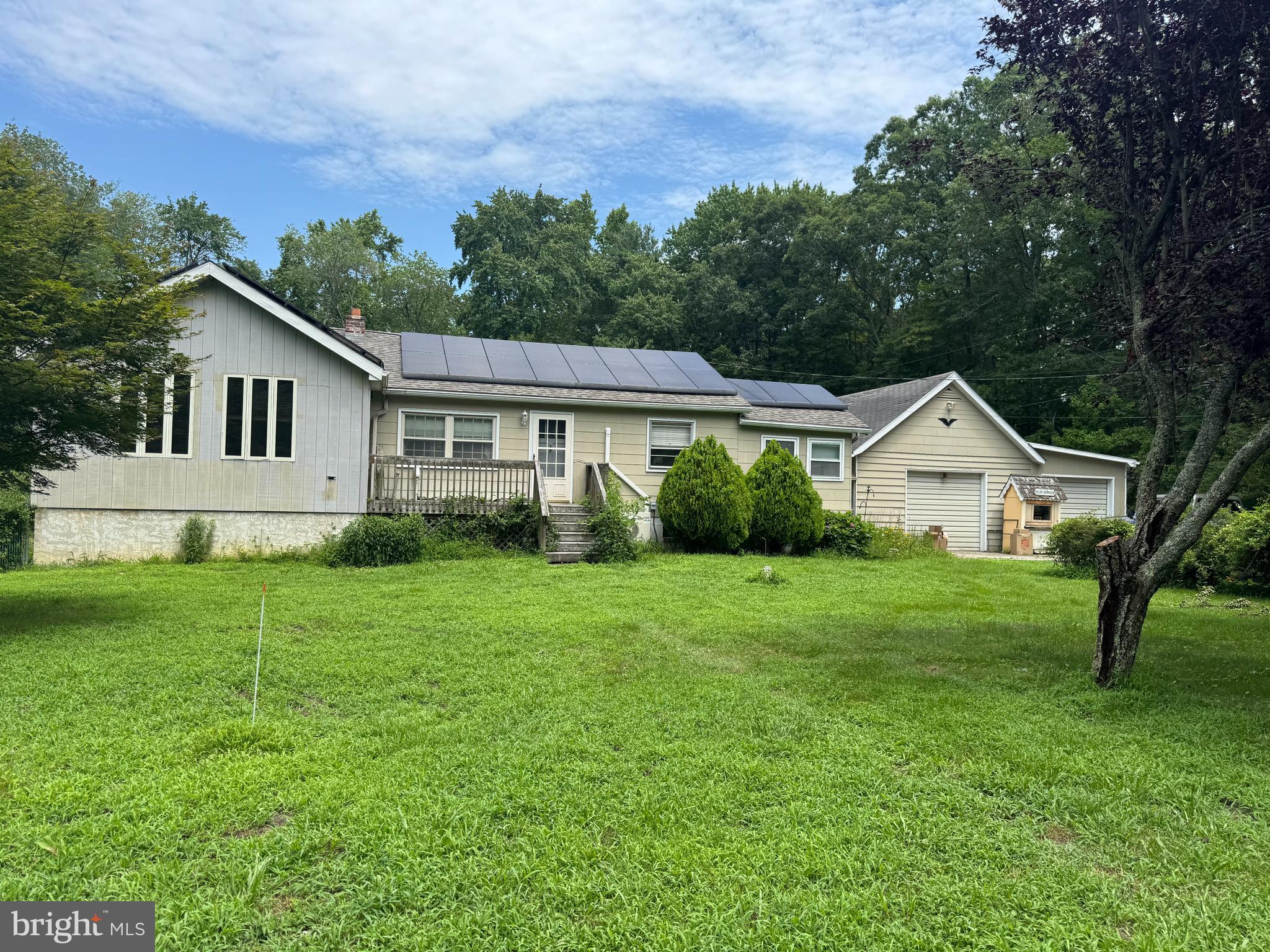 83 Station Road Leesburg, NJ 08327 - Photo 1 of 11 a front view of a house with a yard and trees