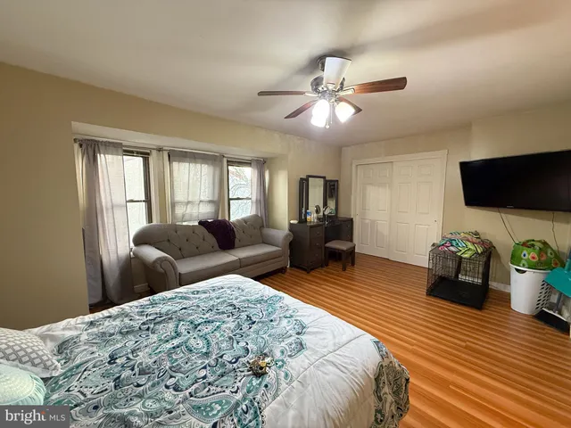 a bedroom with furniture and a flat screen tv