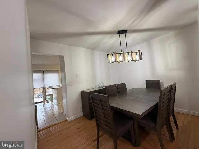 a view of a dining room with furniture wooden floor and a chandelier