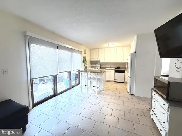 a kitchen with stainless steel appliances a refrigerator and a stove top oven