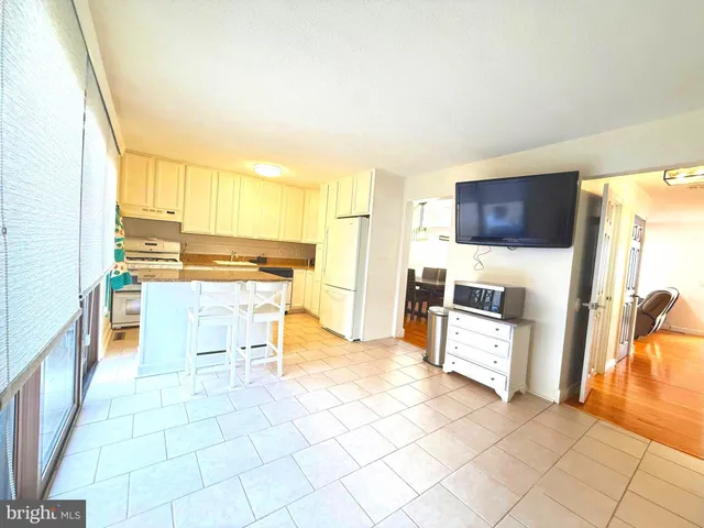 a kitchen with stainless steel appliances a stove a sink and a refrigerator
