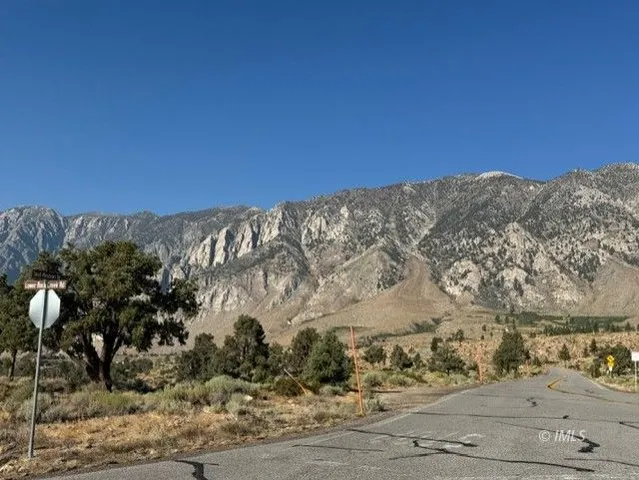 a view of a road with mountains in the background