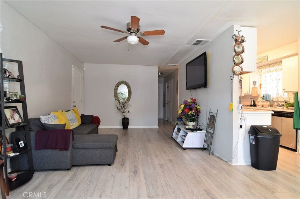 3255 East Avenue R, Unit 98 Littlerock, CA 92550 - Photo 5 of 12 a living room with furniture and a flat screen tv