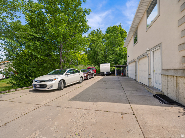 4380 Main Street Logan, UT 84321 - Photo 8 of 74 Concrete driveway leading to a three-car garage