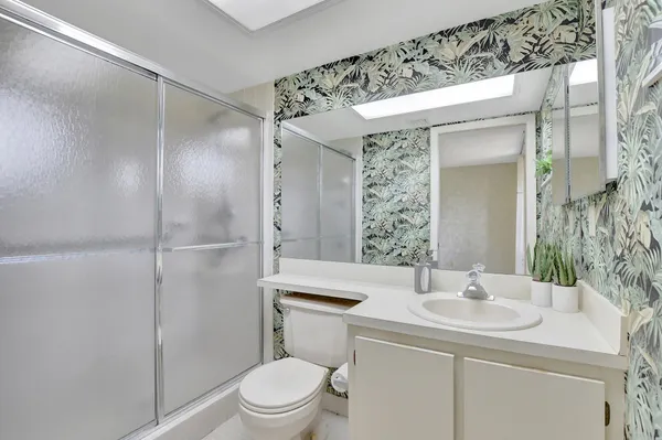 a bathroom with a sink toilet and shower