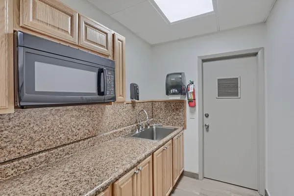 a kitchen with a sink and a microwave