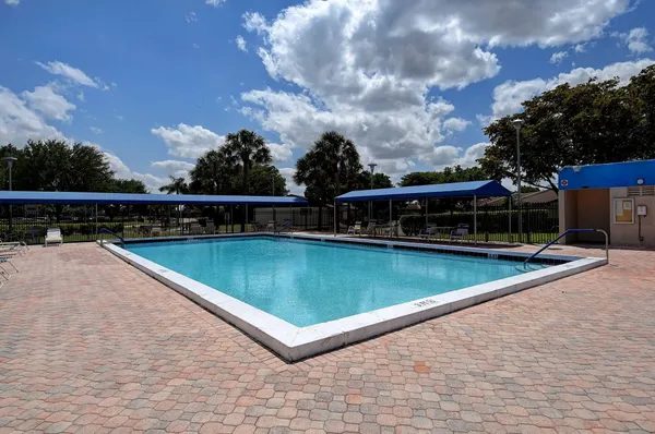 a view of a swimming pool with a yard