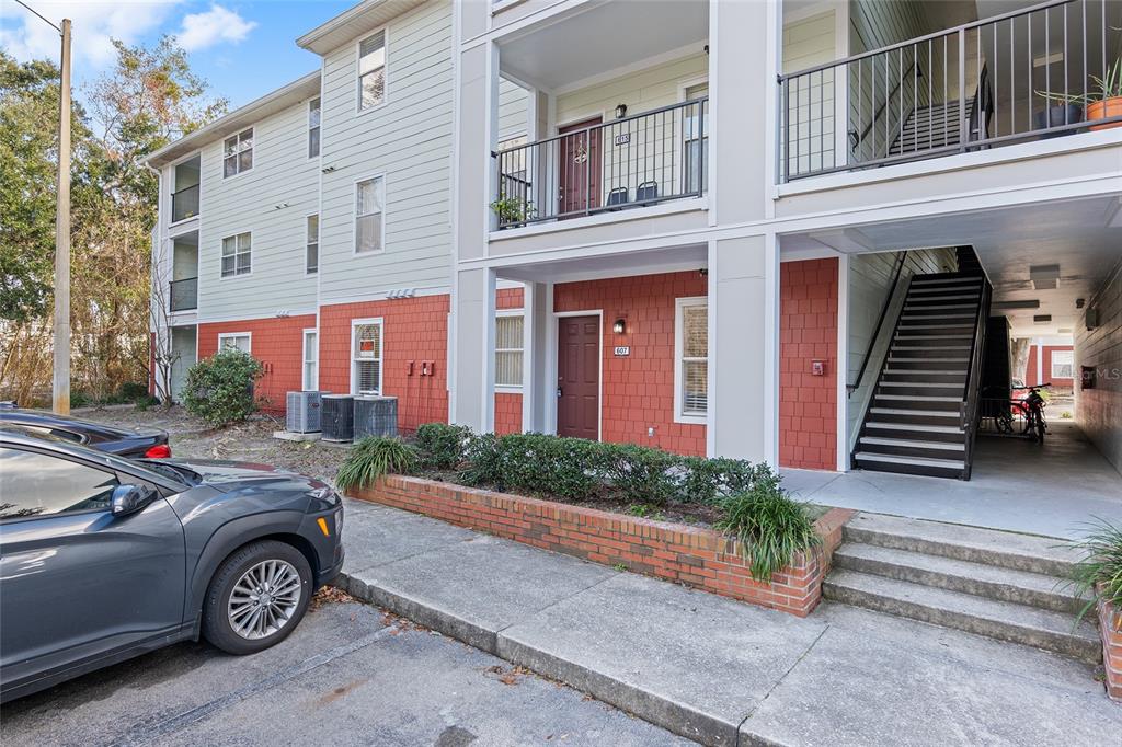 2360 Southwest Archer Road, Unit 607 Gainesville, FL 32608 - Photo 30 of 50 a front view of a house with a garden and parking space
