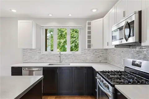 a kitchen with kitchen island a counter top space and a sink