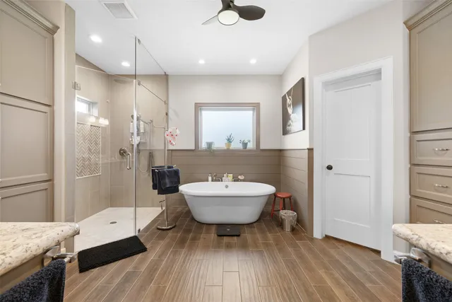 a bathroom with a sink a toilet a mirror and shower