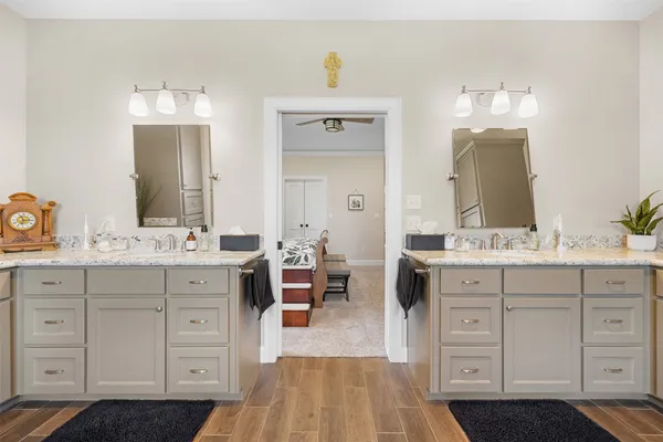 a spacious bathroom with a double vanity sink double and mirror