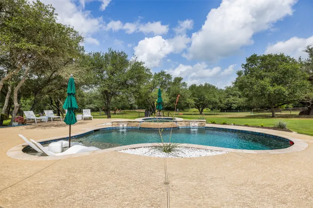 a view of a swimming pool with a yard