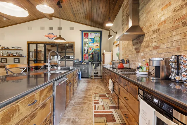 a kitchen with stainless steel appliances granite countertop a sink and cabinets