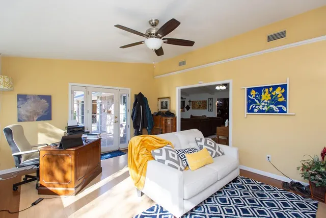 a living room with furniture and wooden floor