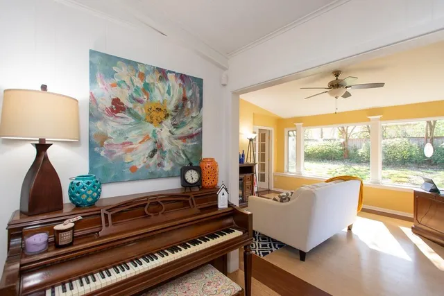 a living room with furniture and a floor to ceiling window