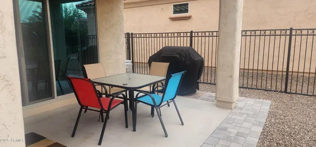 a view of a chairs and table in the balcony