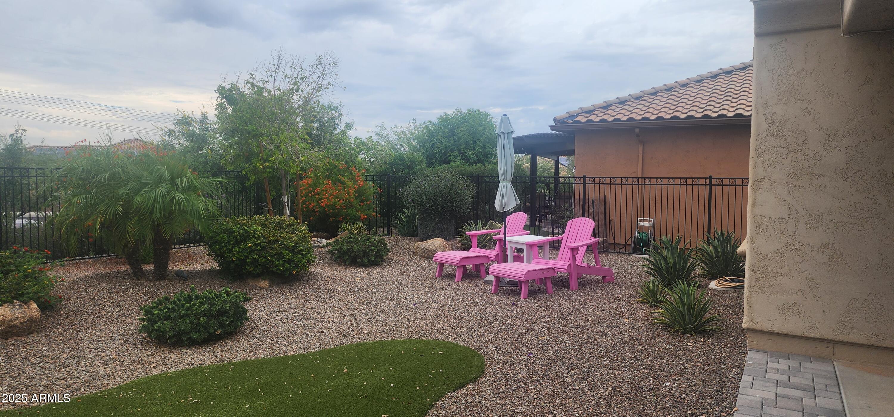 20602 North 274th Avenue Buckeye, AZ 85396 - Photo 15 of 22 a view of a chair and table in backyard of the house