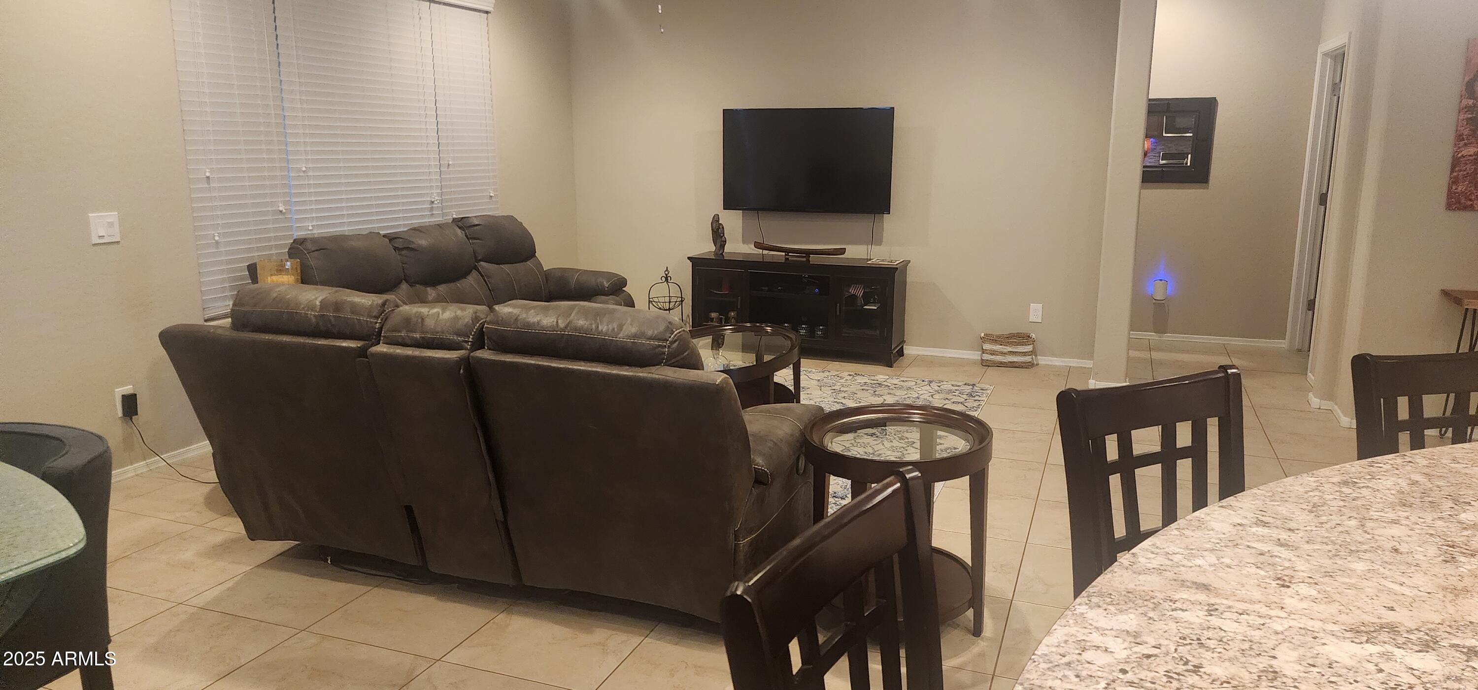 20602 North 274th Avenue Buckeye, AZ 85396 - Photo 3 of 22 a living room with furniture and a flat screen tv