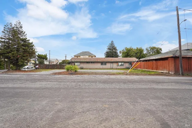 a view of swimming pool with a yard and large trees