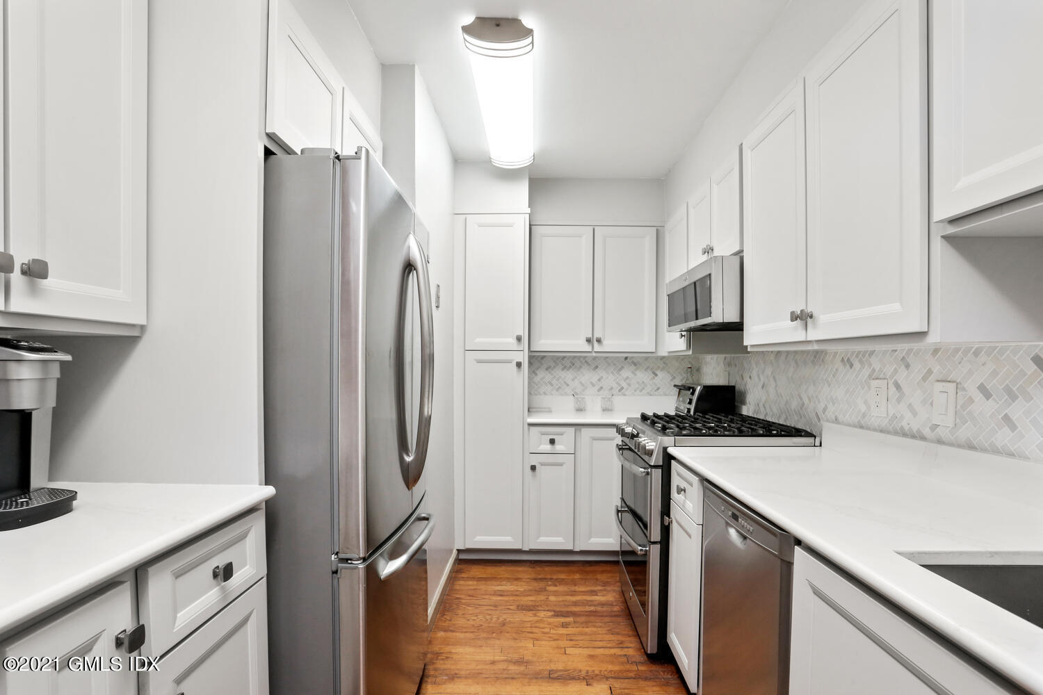 33 Mary Lane Riverside, CT 06878 - Photo 11 of 34 a kitchen with stainless steel appliances a refrigerator sink and white cabinets