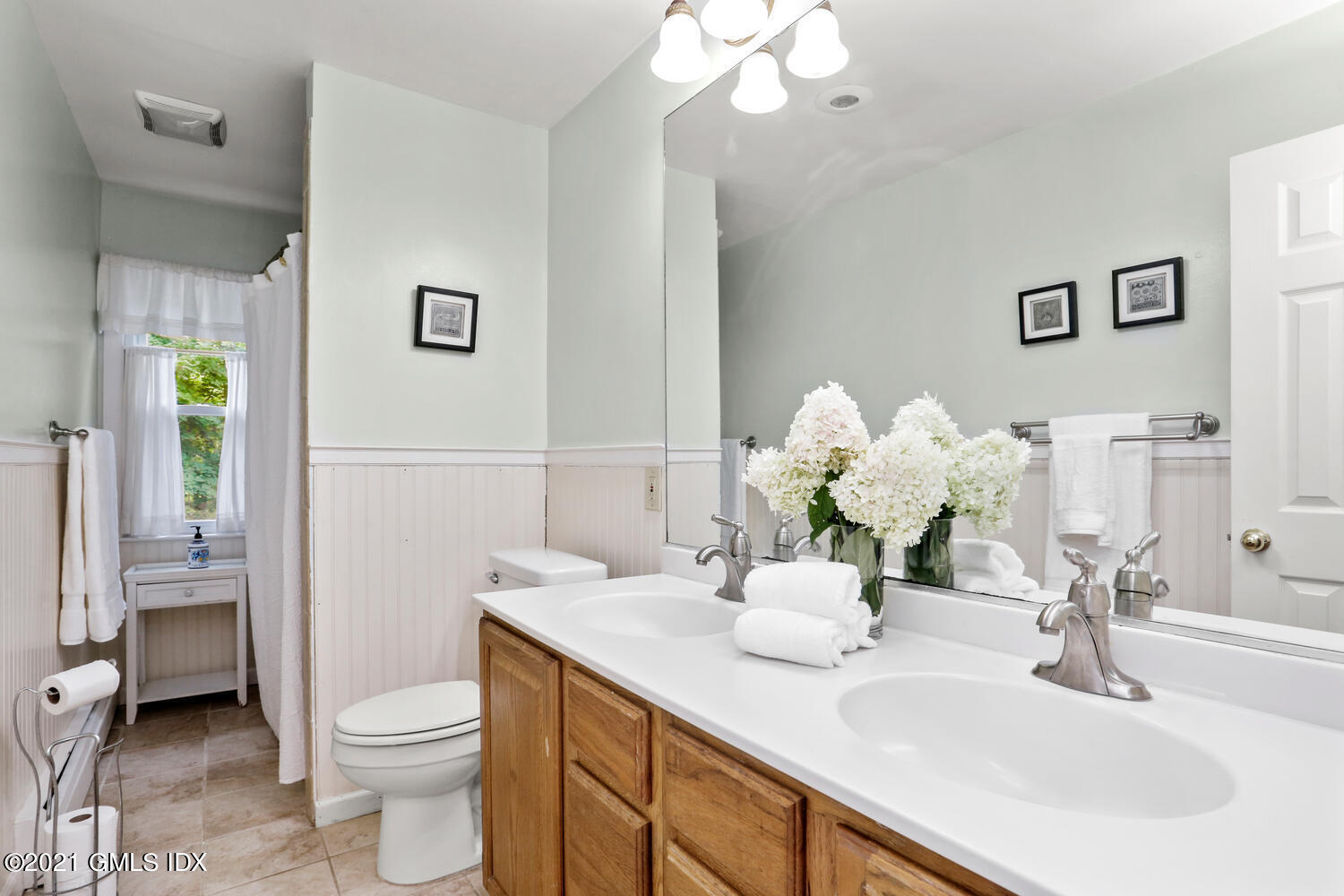 33 Mary Lane Riverside, CT 06878 - Photo 17 of 34 a bathroom with a sink a toilet and a mirror