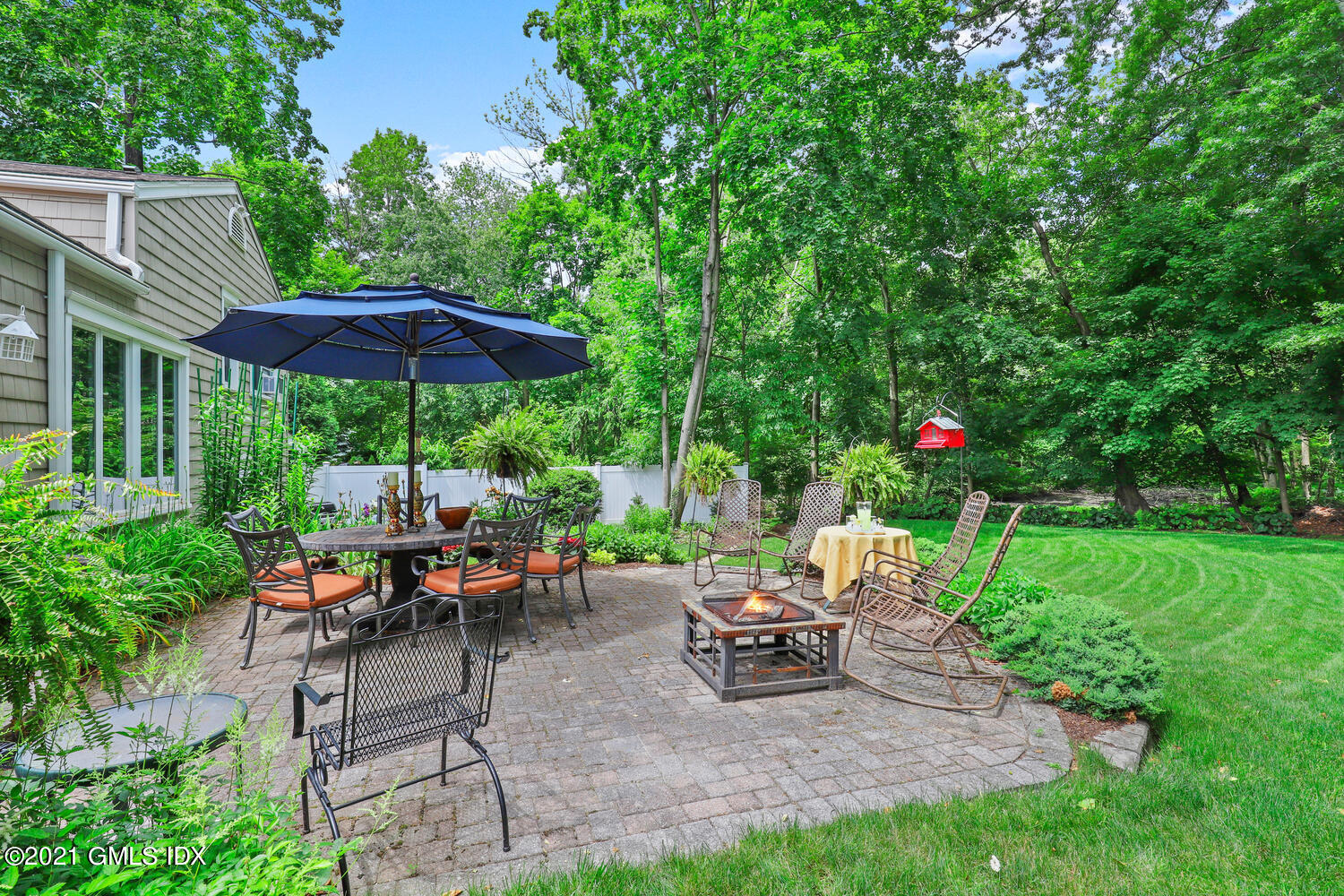 33 Mary Lane Riverside, CT 06878 - Photo 21 of 34 a view of a sitting area with chairs and umbrella
