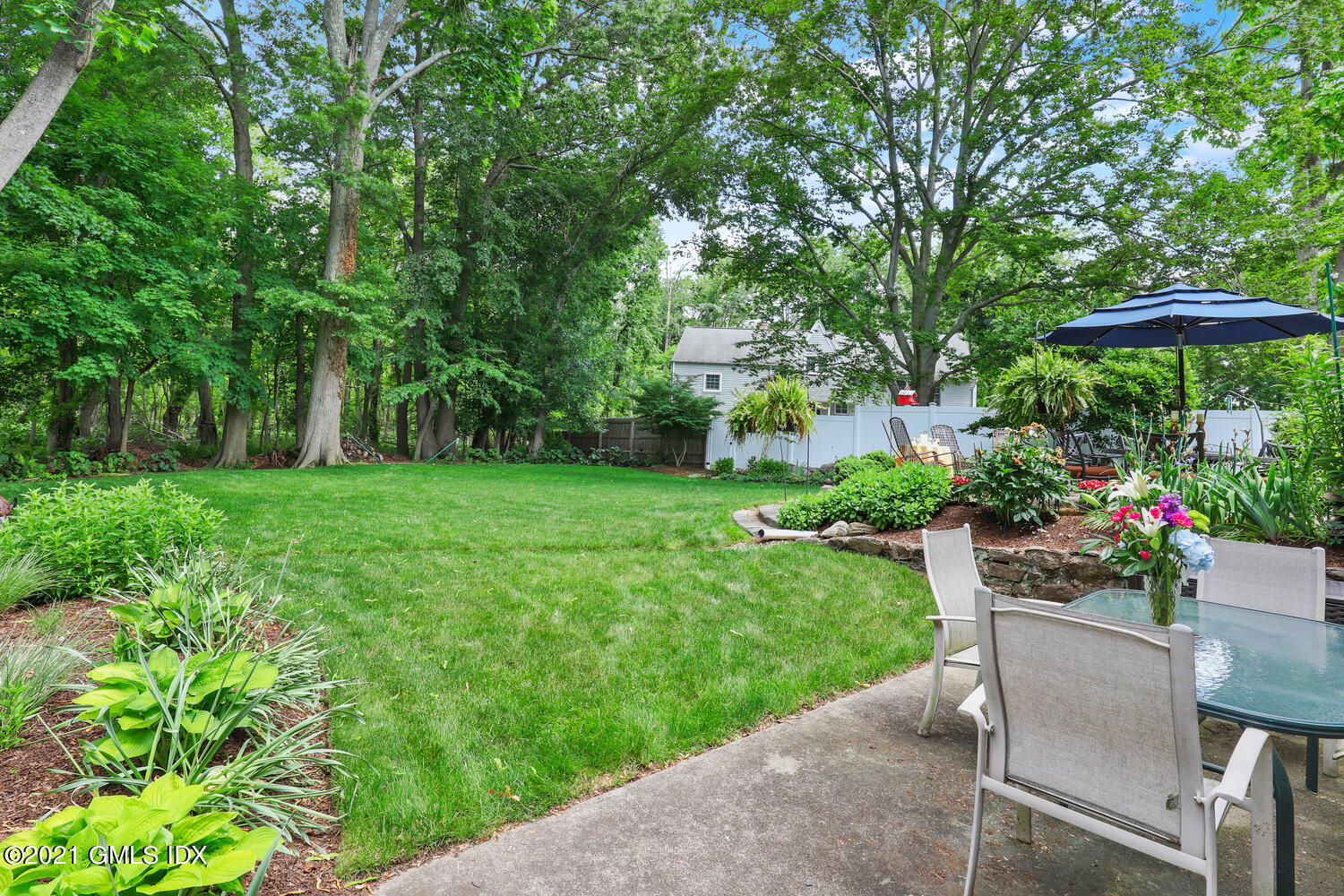 33 Mary Lane Riverside, CT 06878 - Photo 24 of 34 a view of a table and chairs under an umbrella