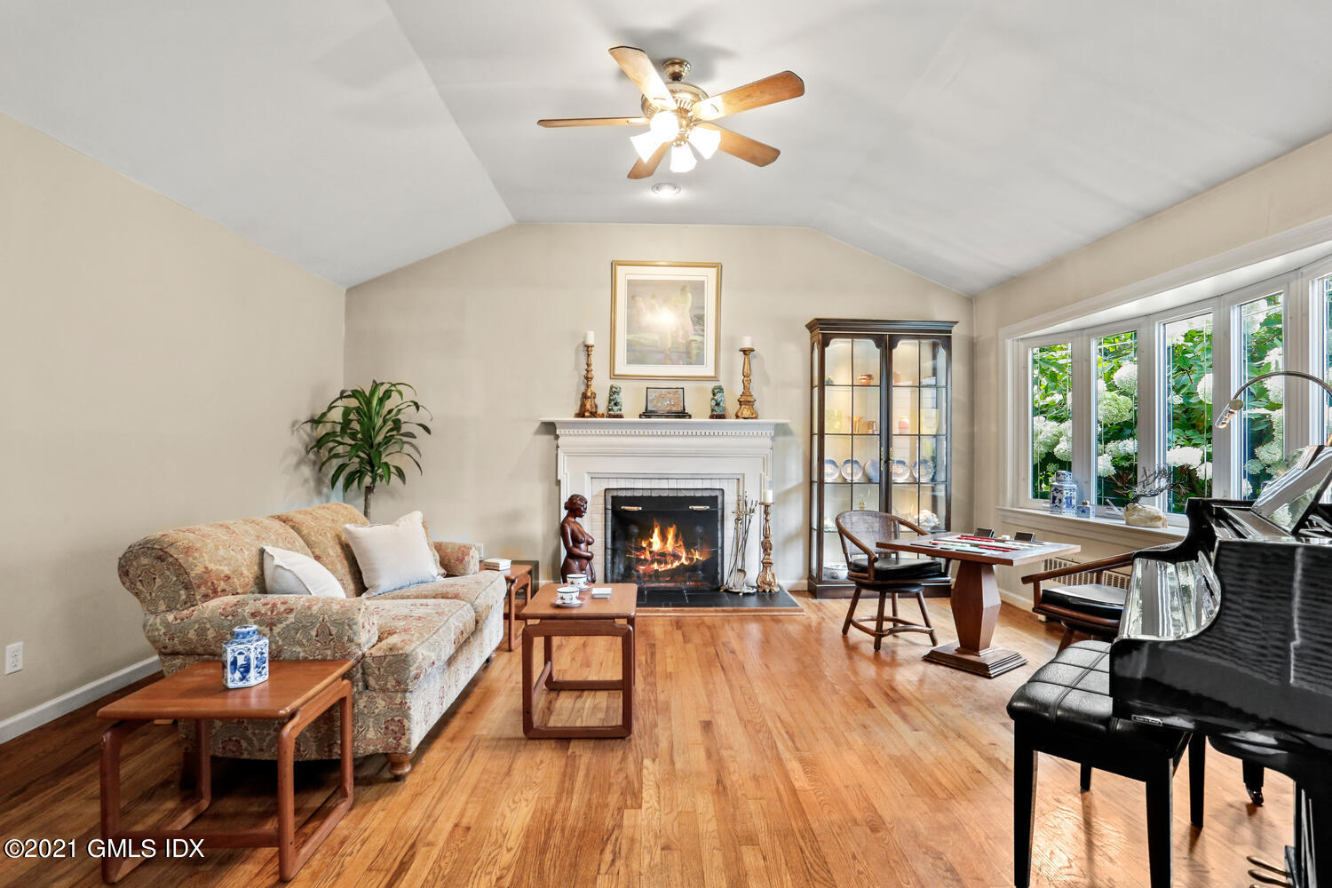 33 Mary Lane Riverside, CT 06878 - Photo 3 of 34 a living room with furniture a fireplace and a floor to ceiling window