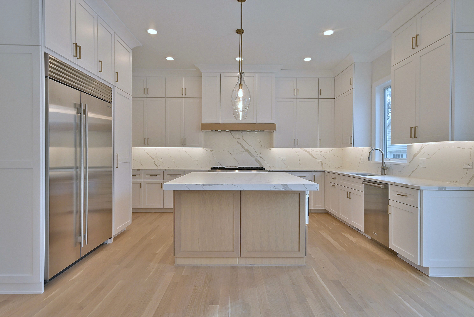 742 Saylor Avenue Elmhurst, IL 60126 - Photo 2 of 2 a kitchen with kitchen island a counter top space a sink stainless steel appliances and cabinets