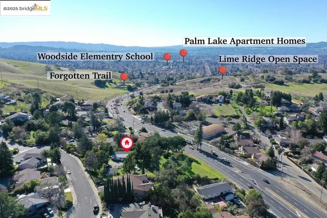 an aerial view of a house with a yard and garden