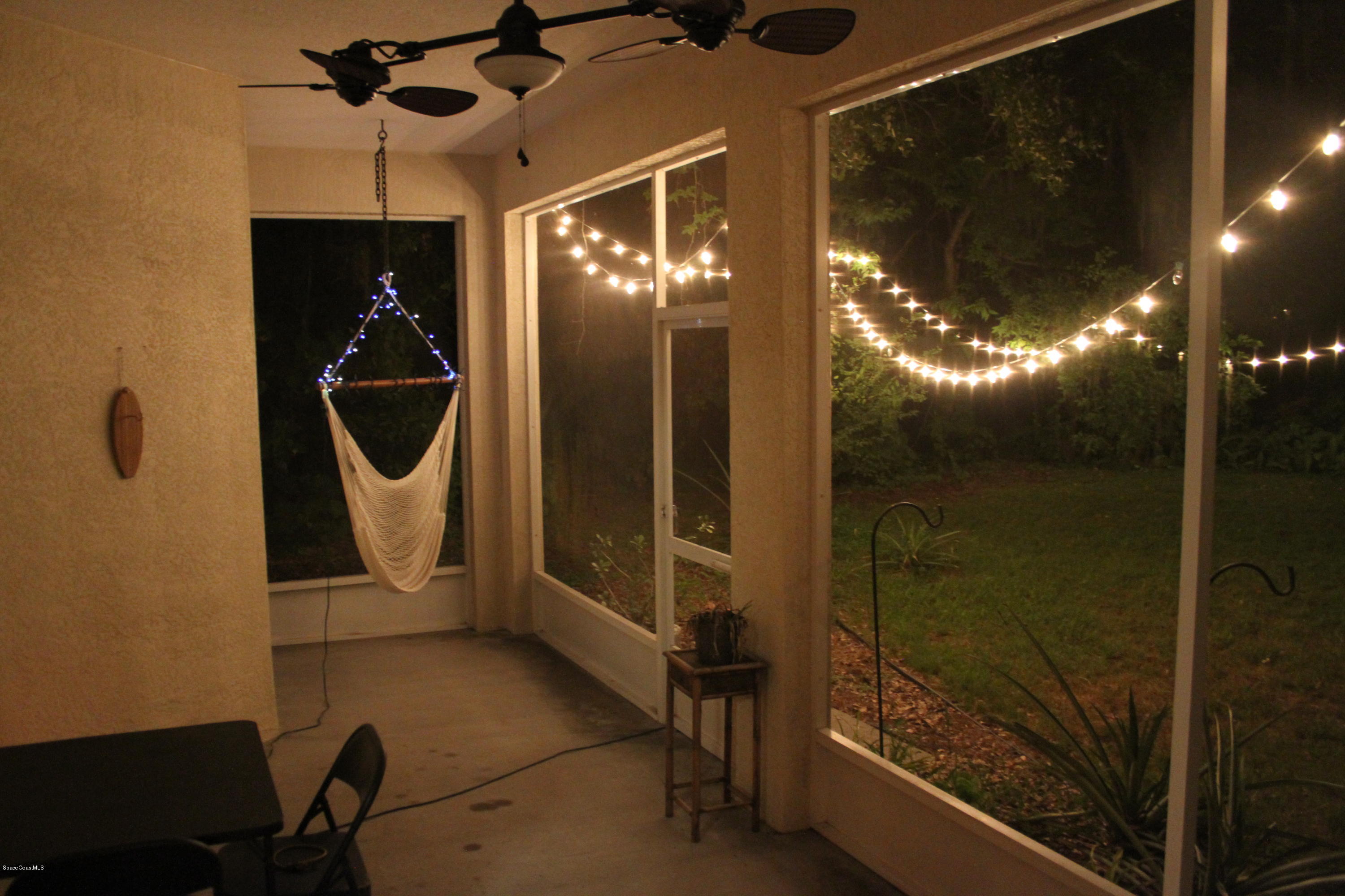 795 Seymour Road Northeast Palm Bay, FL 32905 - Photo 32 of 46 SCREENED PORCH IN THE EVENING