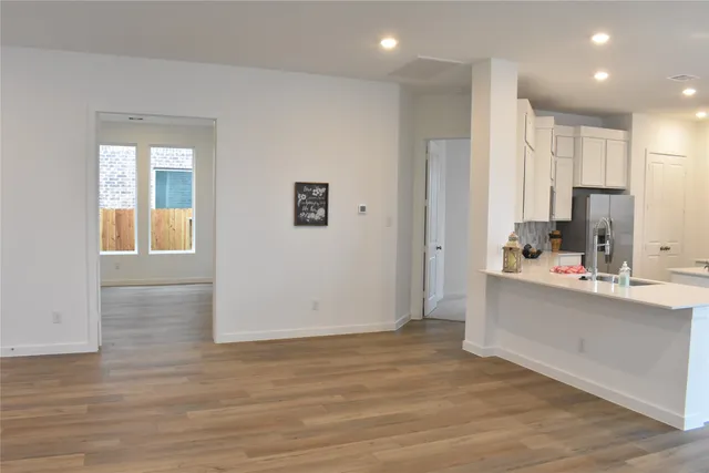 a view of kitchen with stainless steel appliances refrigerator oven and cabinets