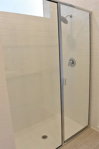 a bathroom with a glass shower door