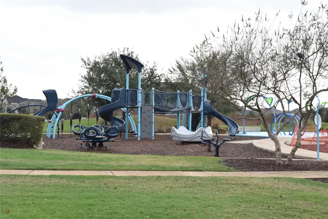 a view of outdoor space with playground and green space