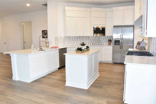 a kitchen with a sink stove and refrigerator