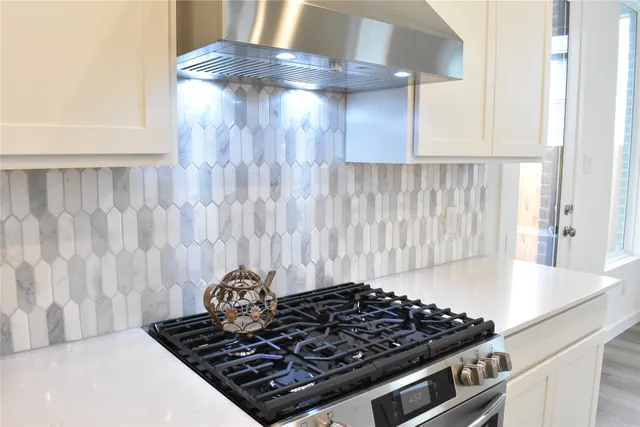 a close view of a stove top oven sitting inside of a kitchen