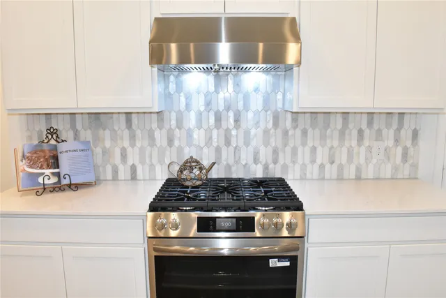 a kitchen with a stove and cabinets